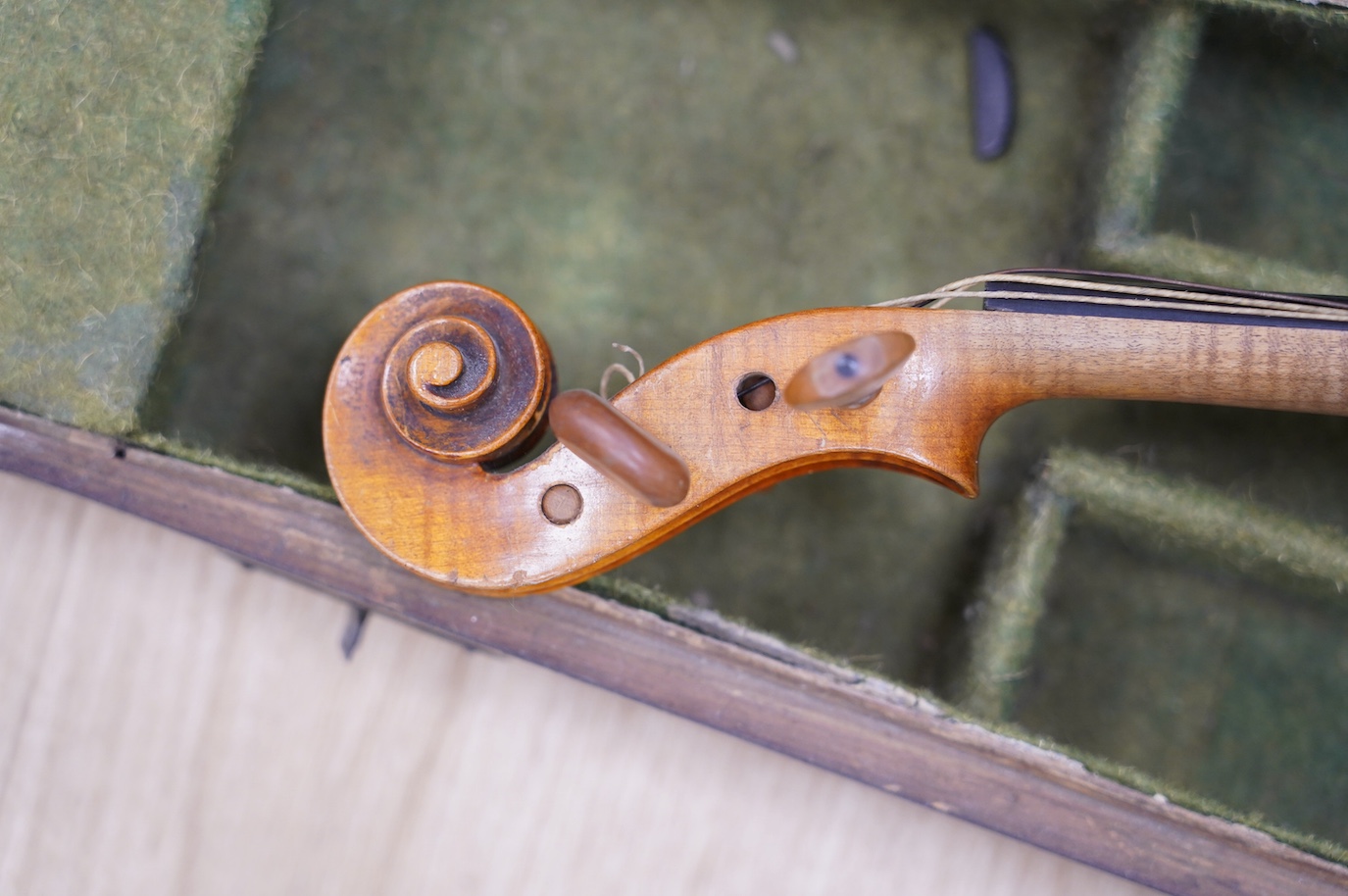 A late 19th century German violin, bearing a Stradivarius label, dated 1717, with mother of pearl inlaid tailpiece, in a walnut case and with bow, the bow stamped Vuillaume & Paris. Condition - fair